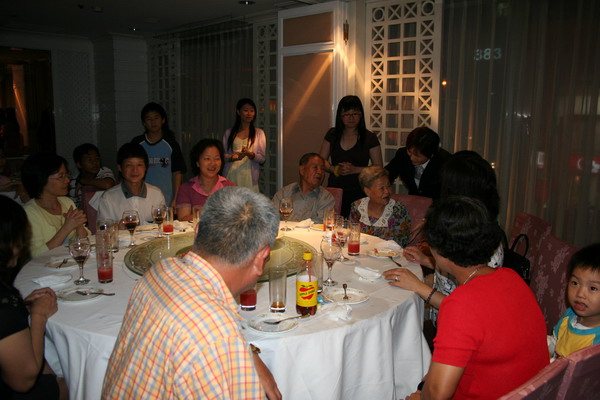 a large group of people are around a dinner table