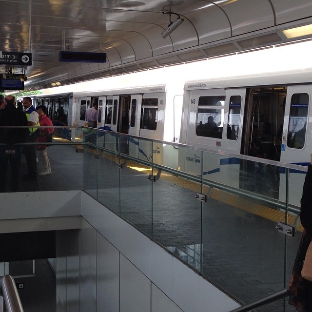 a group of people waiting for the subway to stop