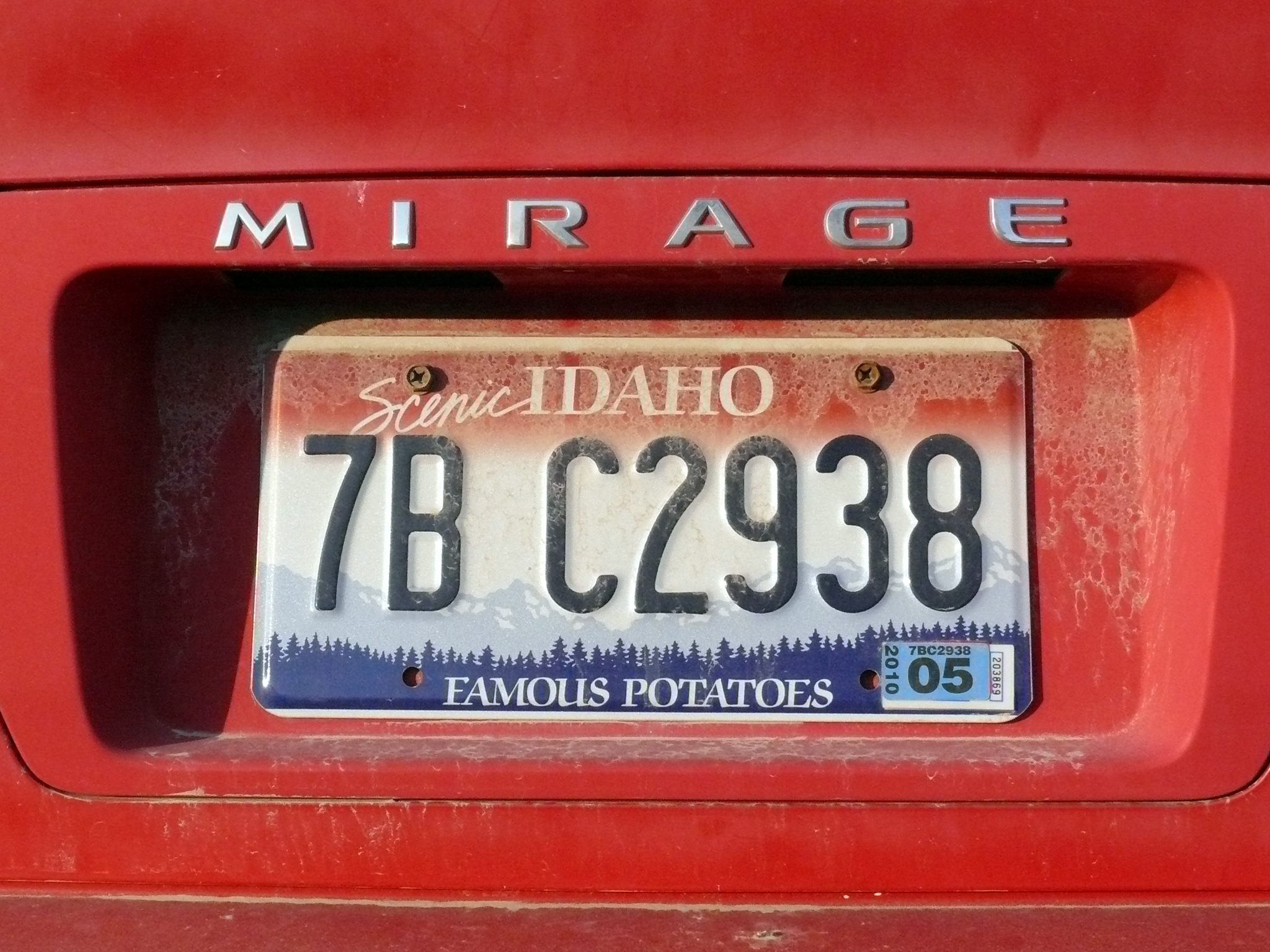 an old, red car has a license plate