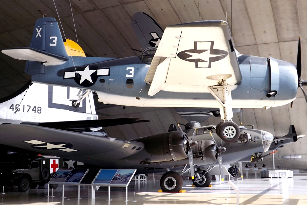 four war planes hang on display in the air museum