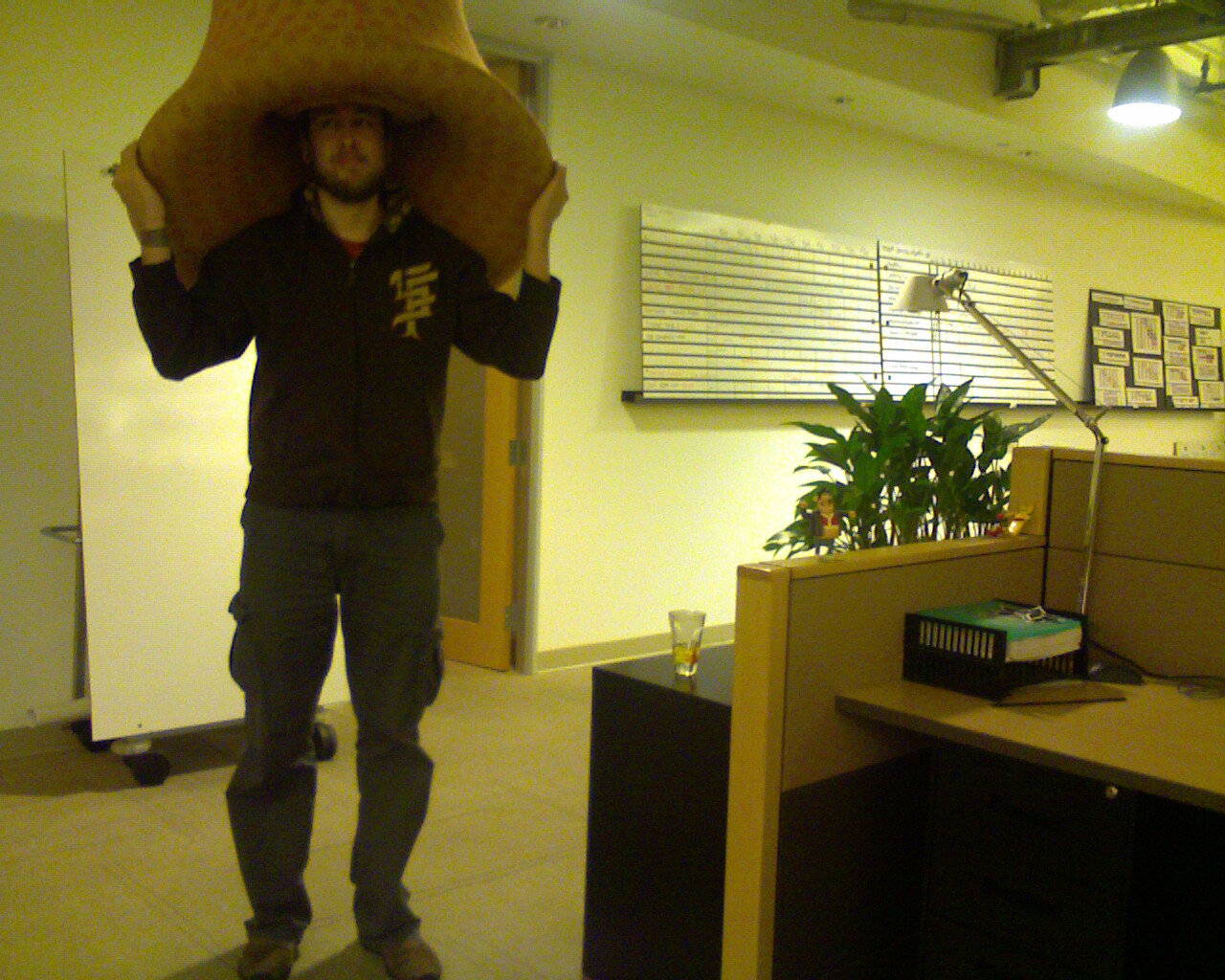 a man carrying a big sack on his head