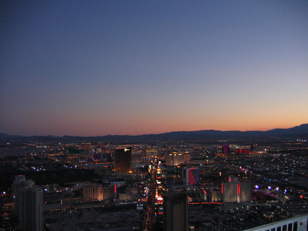 city at night with lights all lit up and buildings lit up