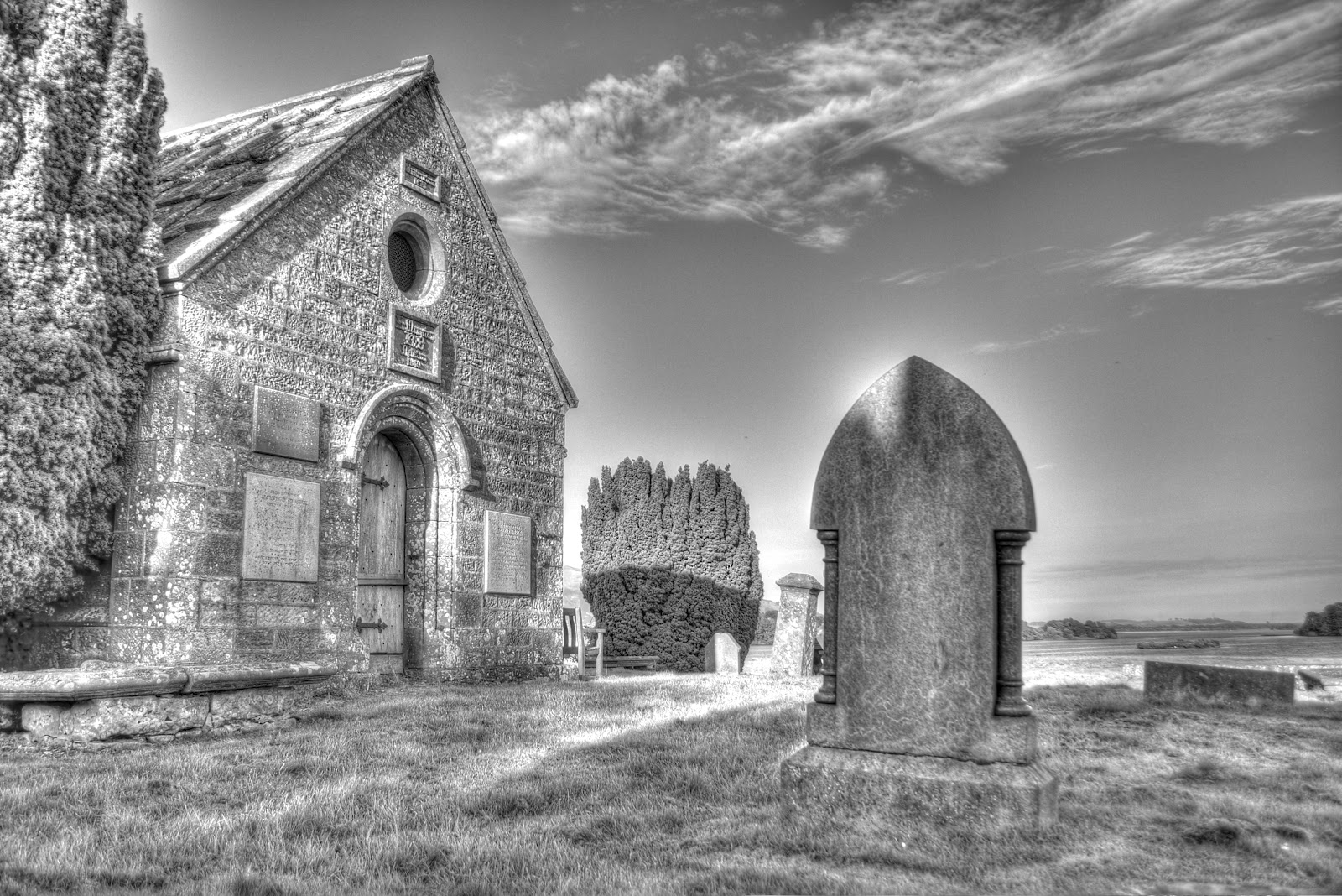 a church in front of a graveyard is shown