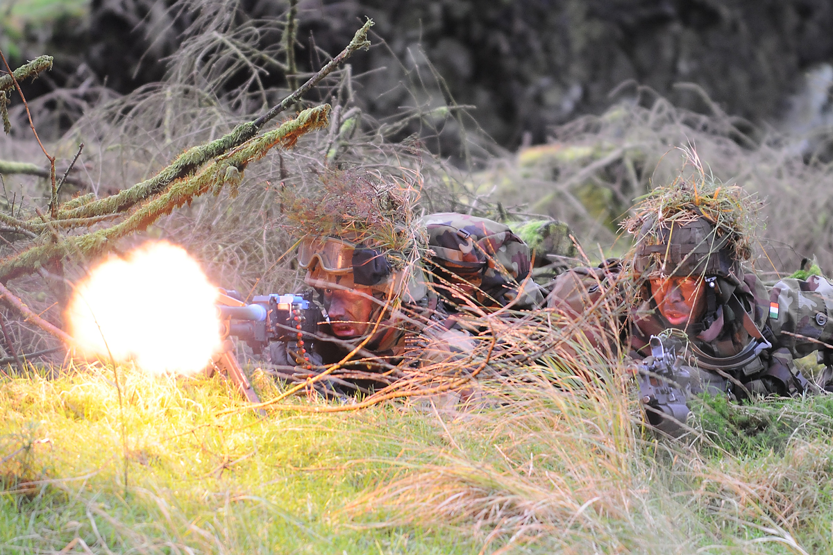 a group of people in military gear are laying down