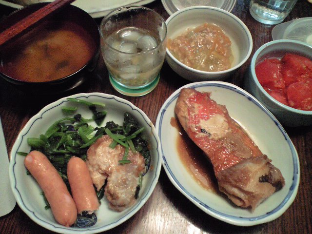 bowls and plates are sitting on a table, with a variety of food items