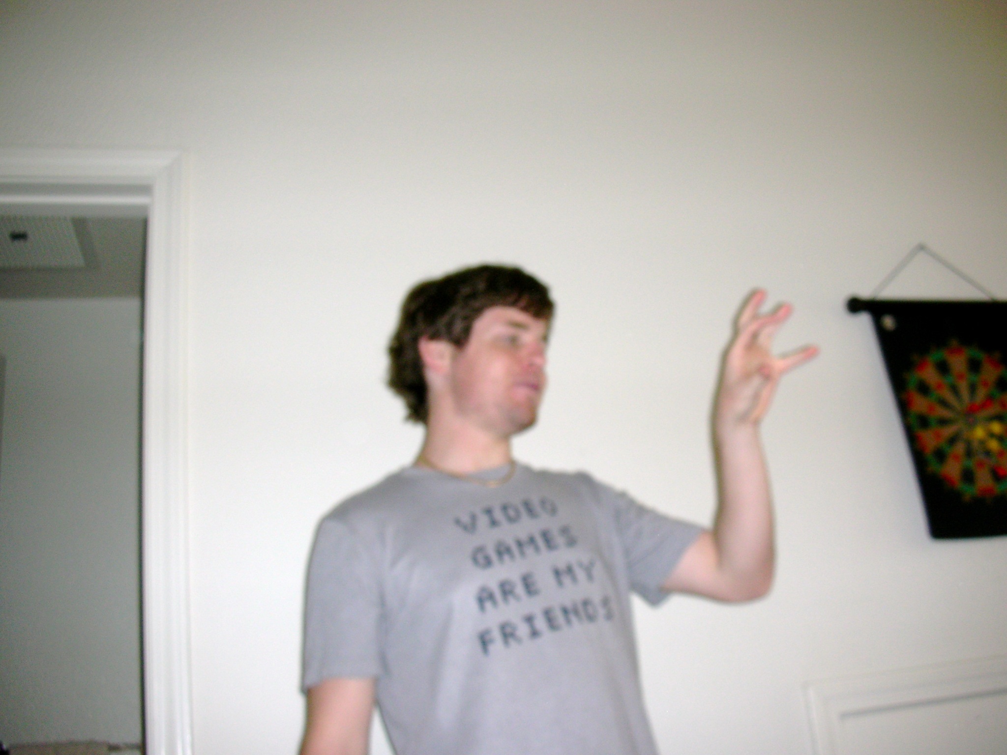 a man standing up holding his hand out and making a weird gesture