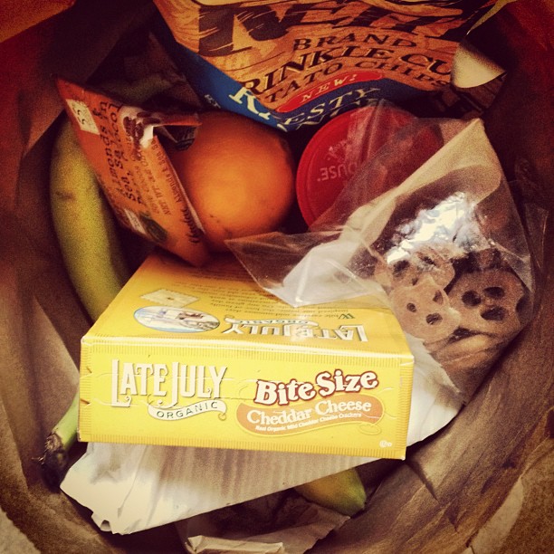 bananas, bananas, chocolate, and cookies sit in a basket