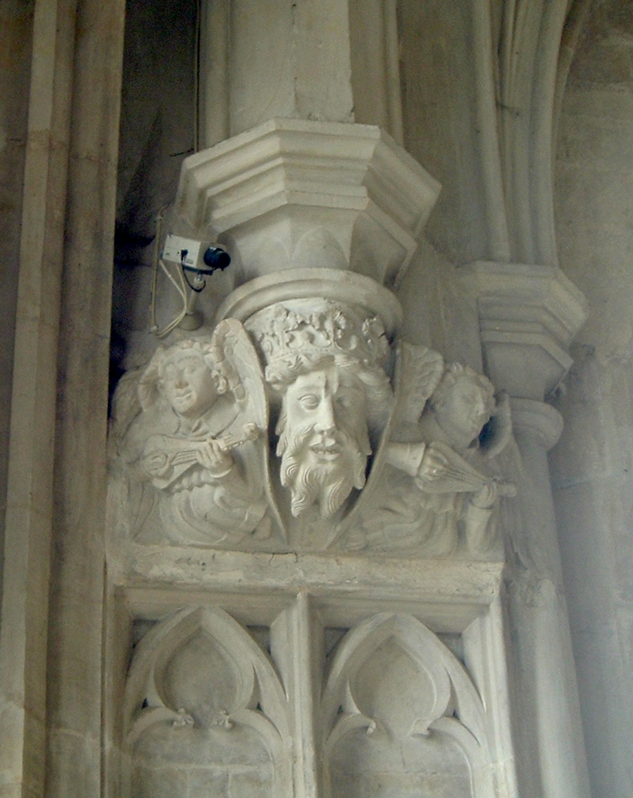 statues of busturines on a pillar on a building