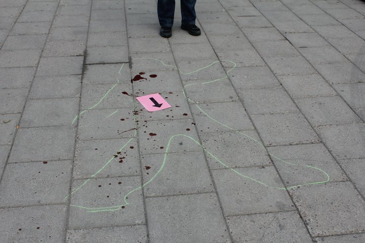a  is standing on the sidewalk with chalk drawings