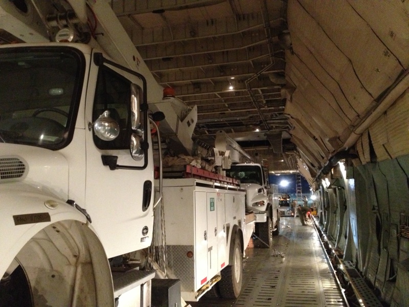 a line up of trucks parked in a storage area