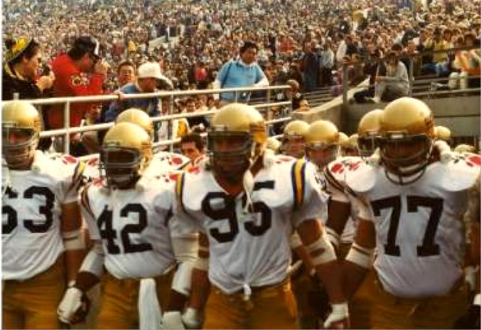 football players are lined up to walk onto the field