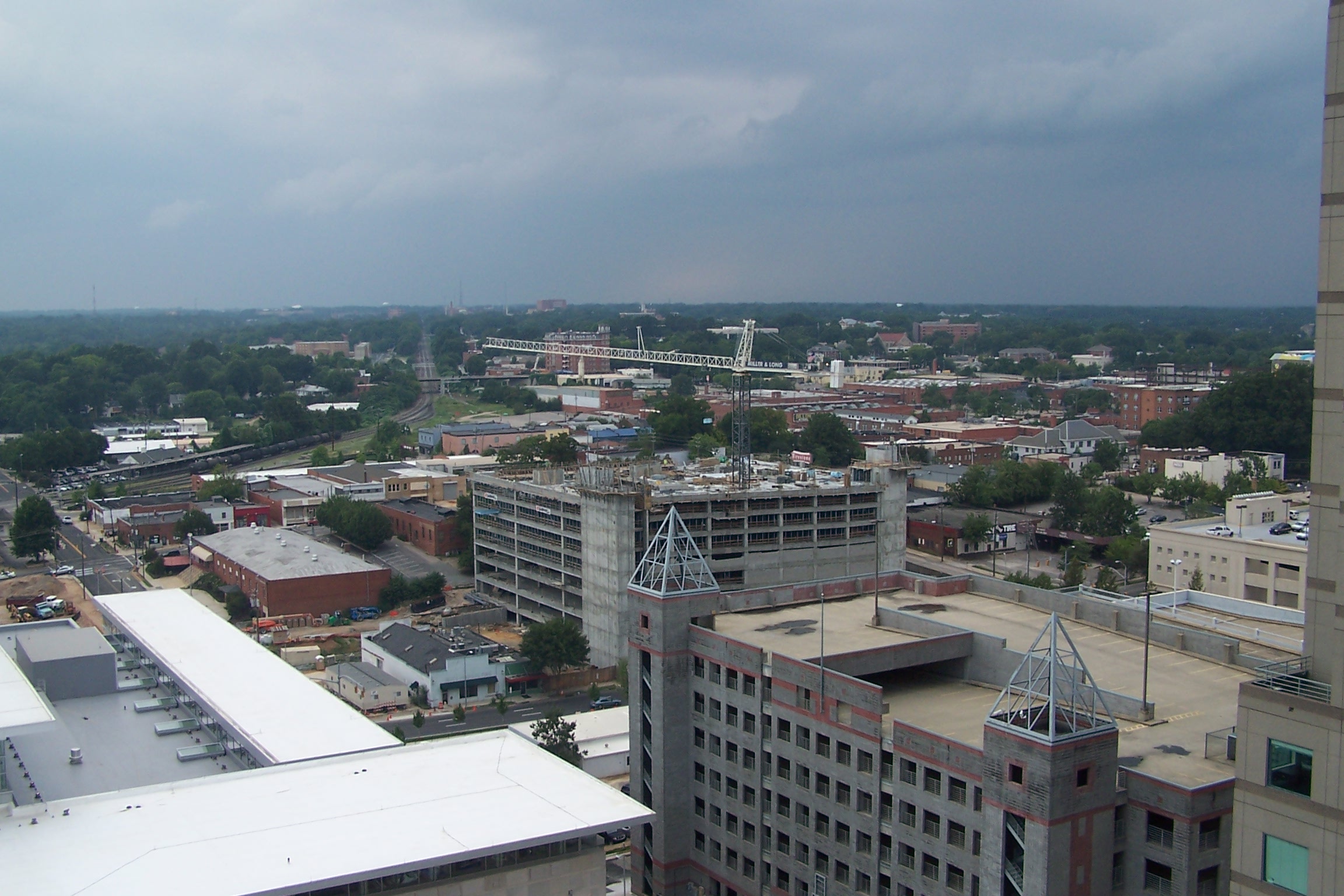 a city with buildings all around and dark clouds overhead