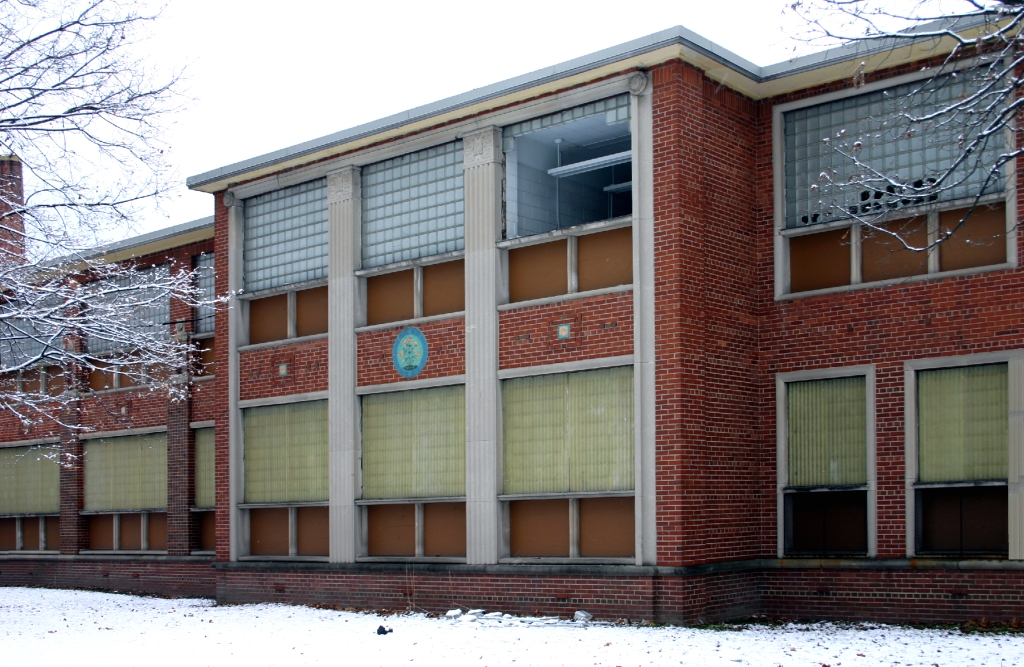 a brick building with windows that has snow on the ground