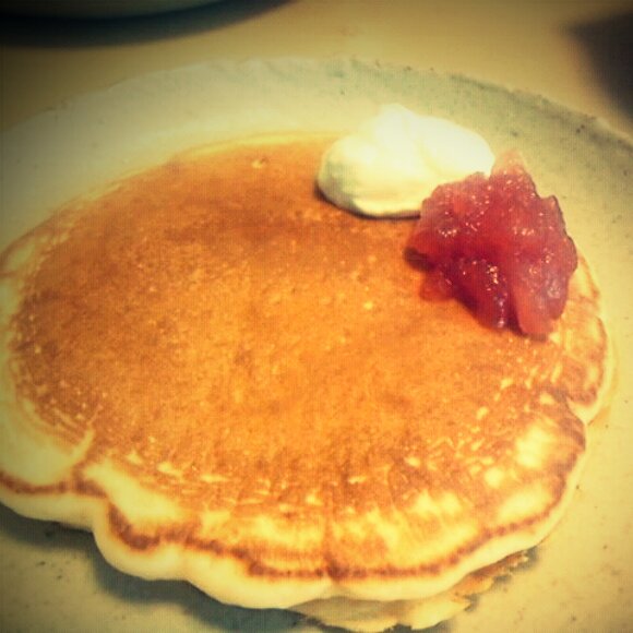 pancakes, including er and jam sit on a plate