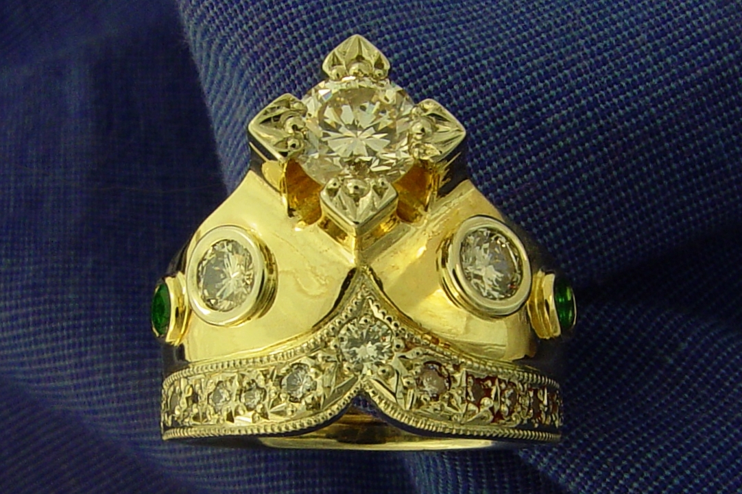 a gold ring with many different jewels on top