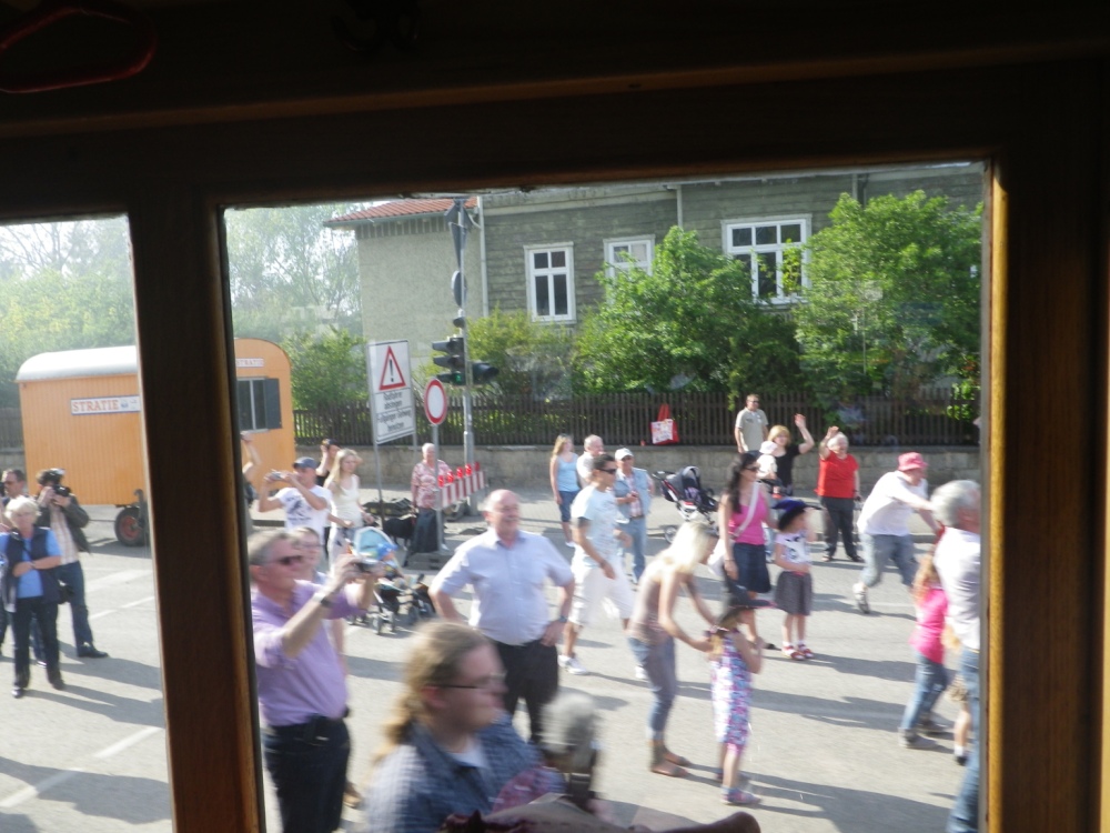 a group of people gathered outside by some buildings