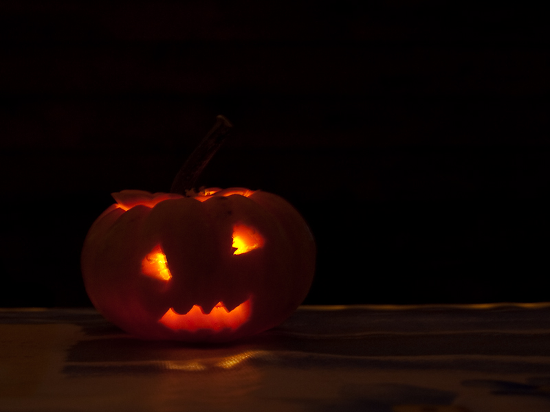 a lit pumpkin sitting in the middle of a table