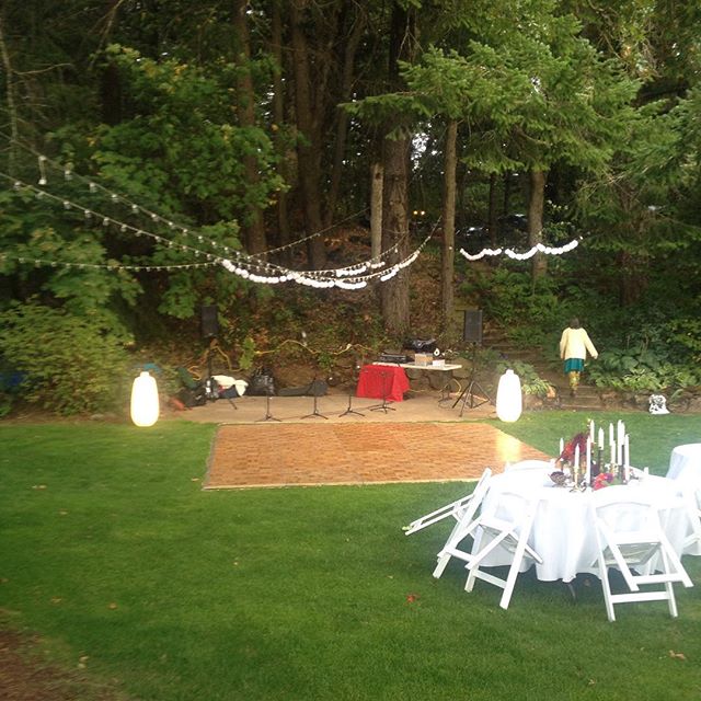 an outdoor wedding with dinner table and chairs set up