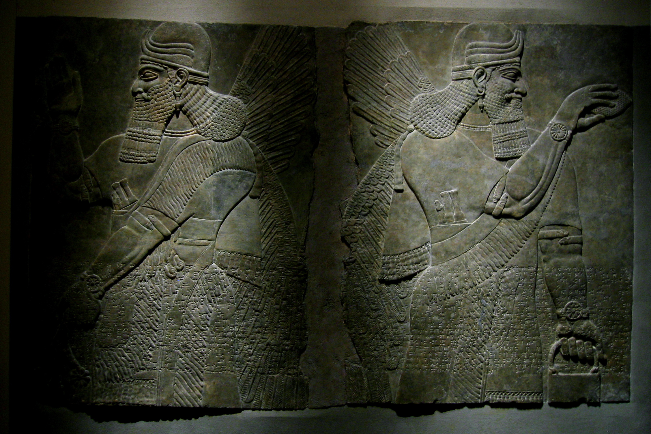 two ancient egyptian stele showing the side panels of men sitting