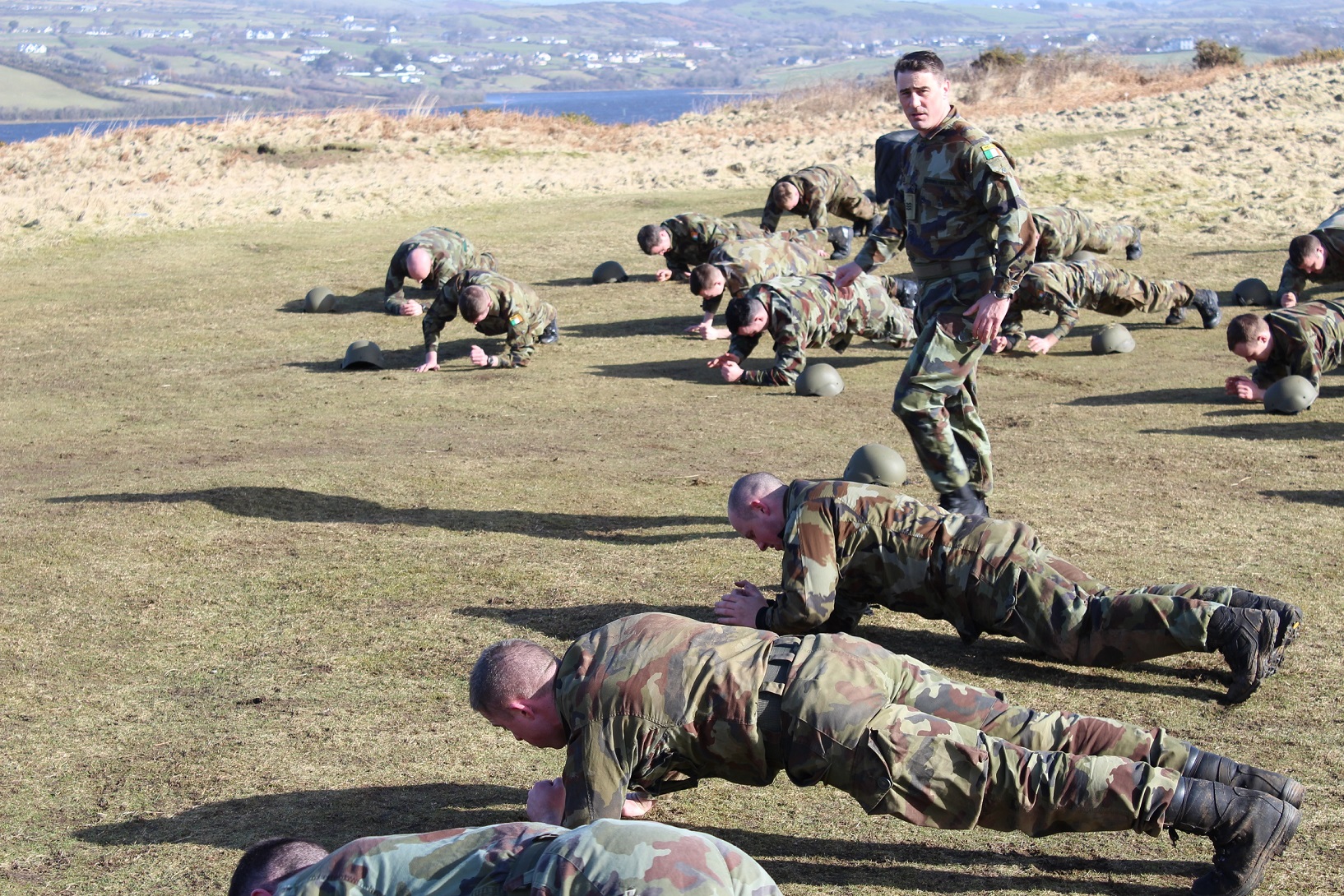 a soldier standing over a bunch of other soldiers