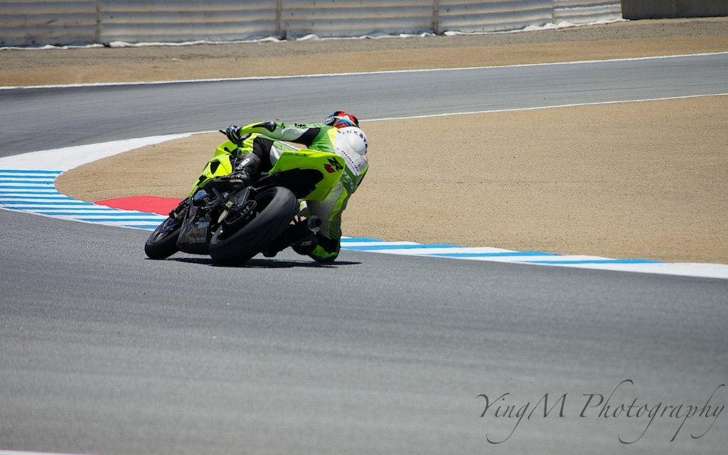 a motorcycle racer turning a curve on a racing track