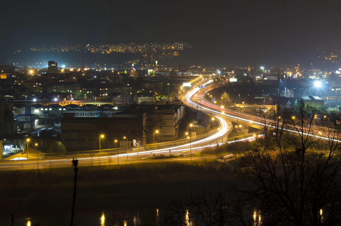 cars driving along an interstate at night time