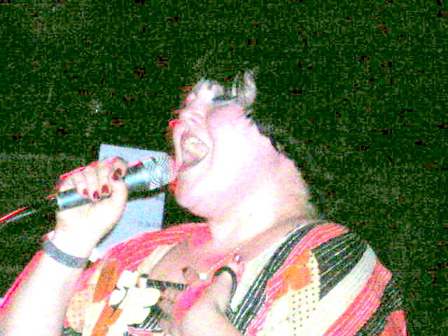 a man on stage singing into a microphone