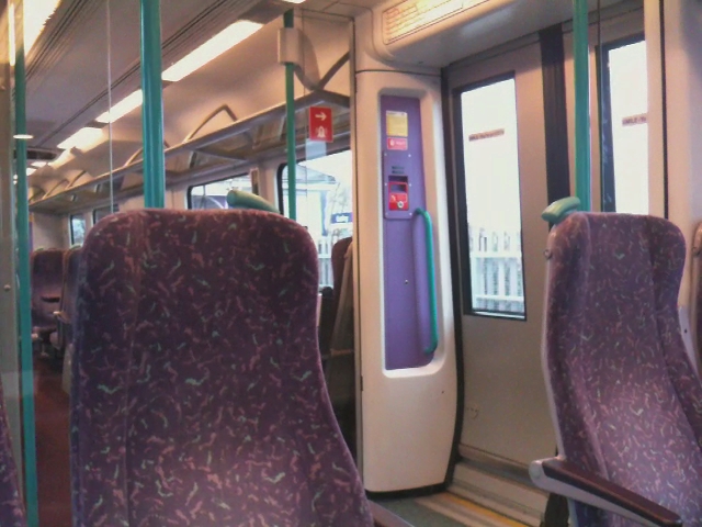 purple seats inside a public transportation vehicle on a train