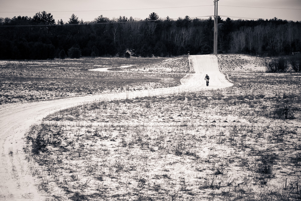 a man walks down a dirt road toward a sign that says, i don't walk