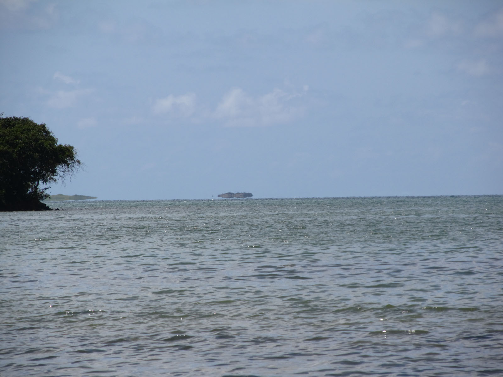 a boat is out in the ocean on a clear day