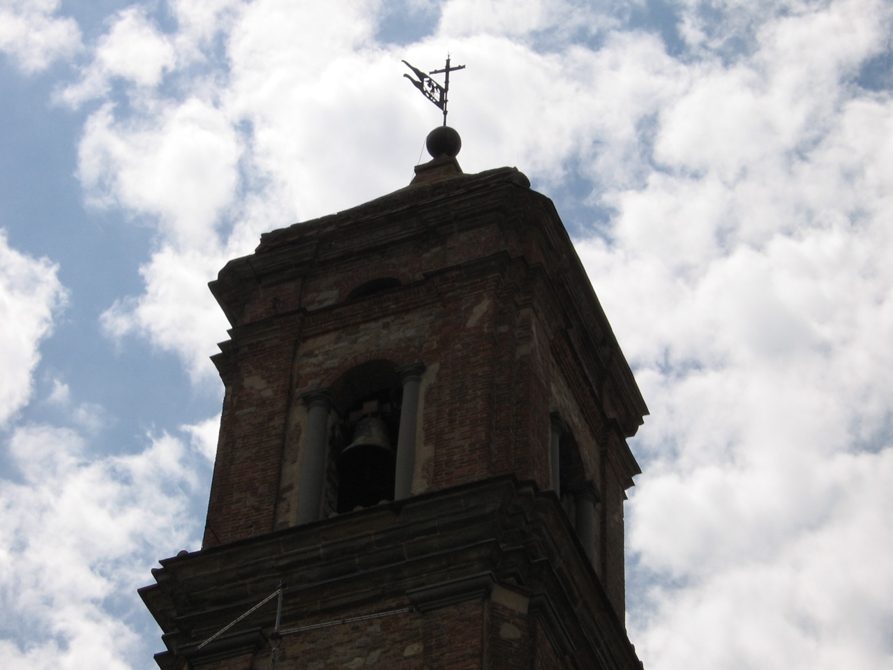 the tower has a cross on top and a bell on the top