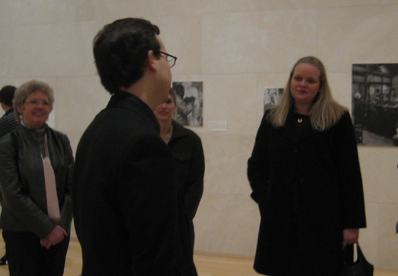 a woman standing next to a man at a museum