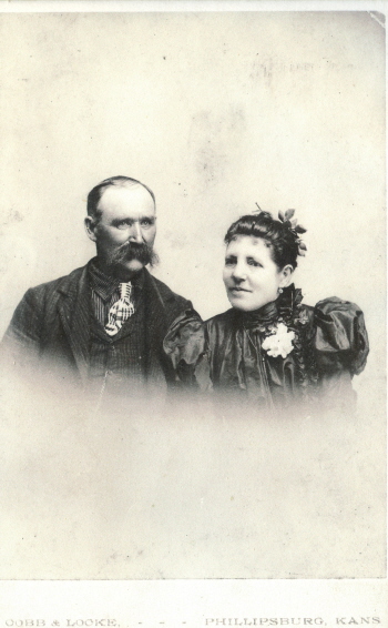 a couple poses in formal dress while holding hands