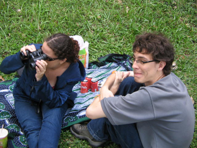 two people sitting on the ground and having drinks