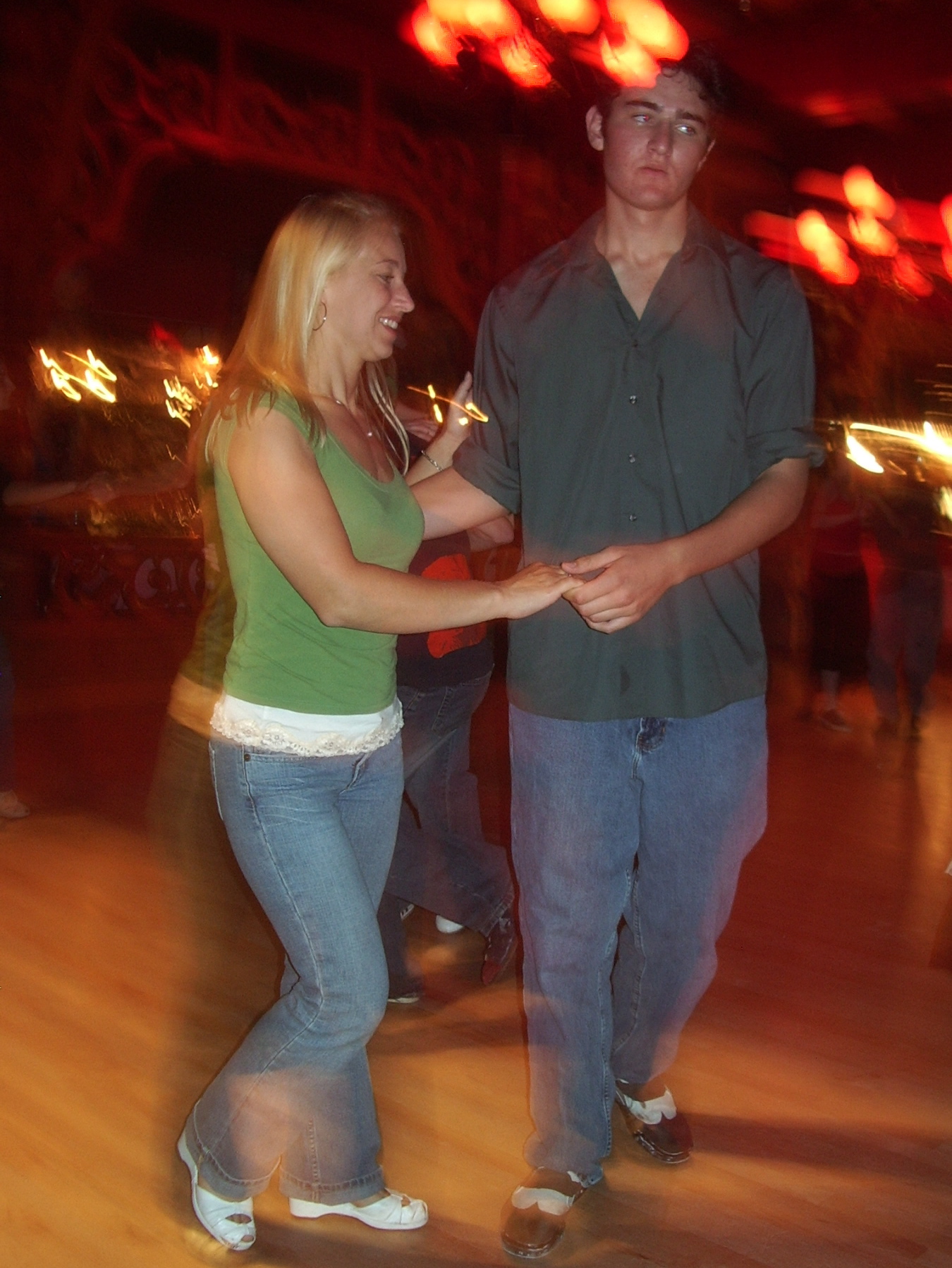a couple is dancing at a public dance