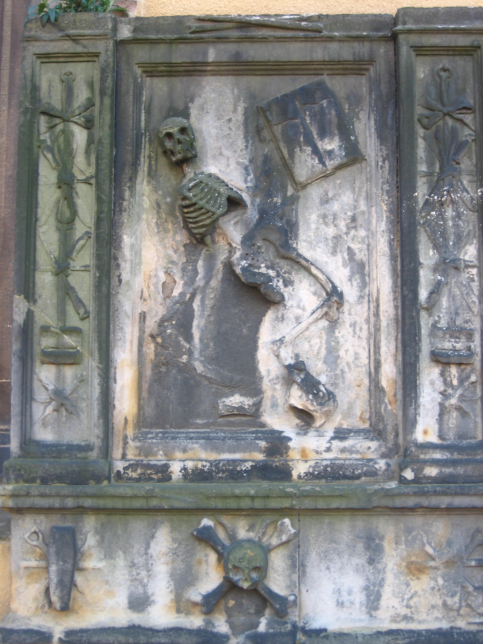 a statue depicting a skeleton on a building