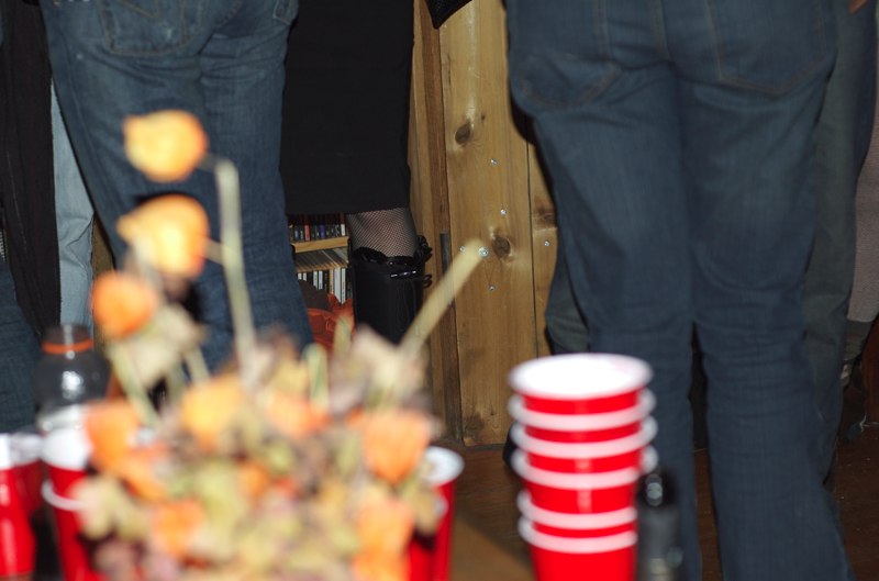 people standing in a room full of red cups