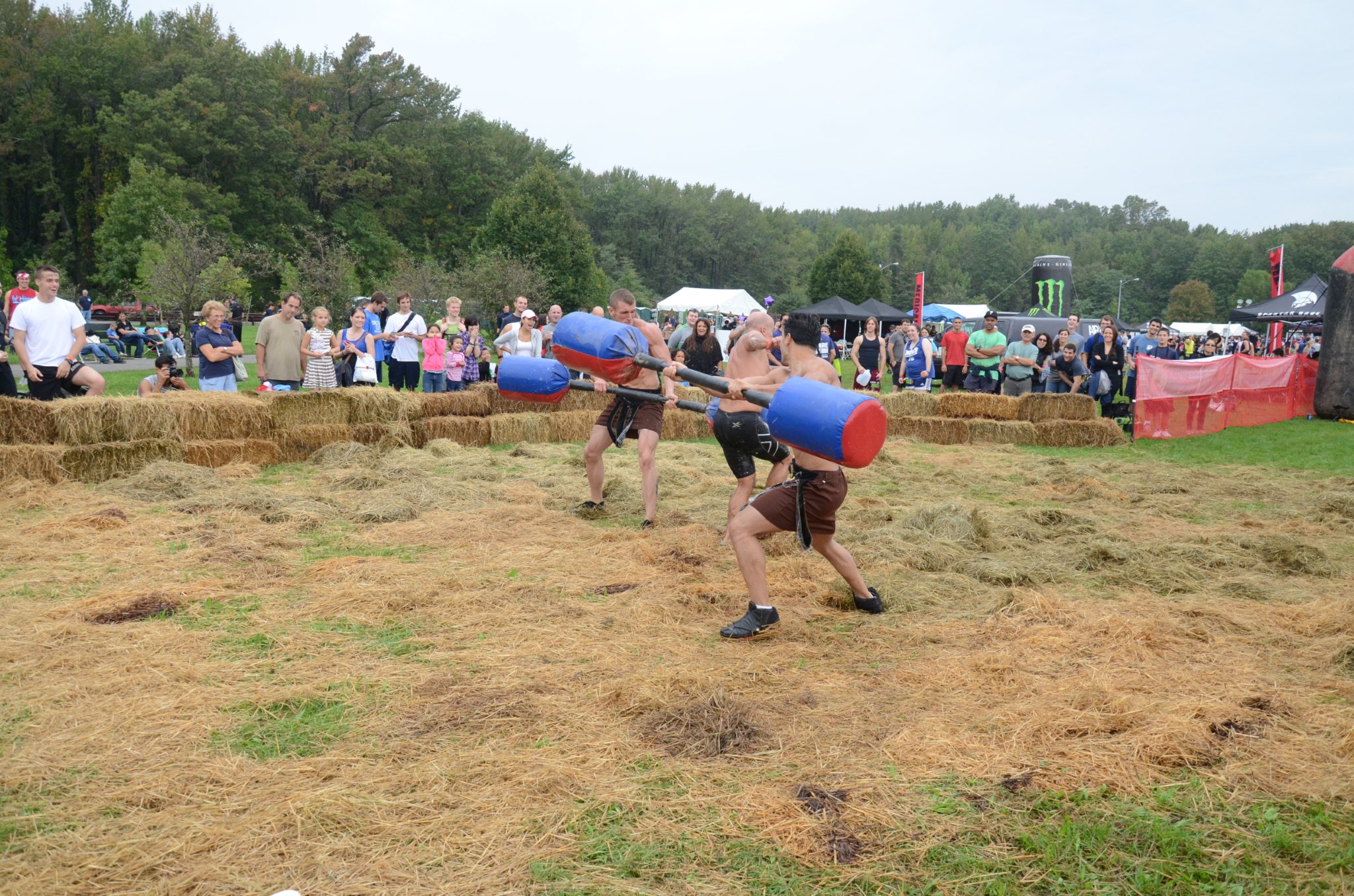 two men are fighting with two red and blue barrels