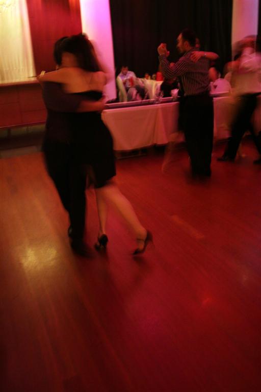 two people are dancing and dancing on a wooden floor