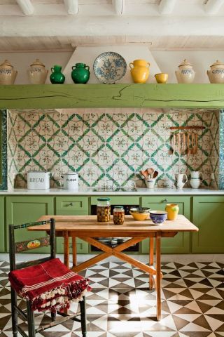 a kitchen with green and white checkered floor and painted cabinets