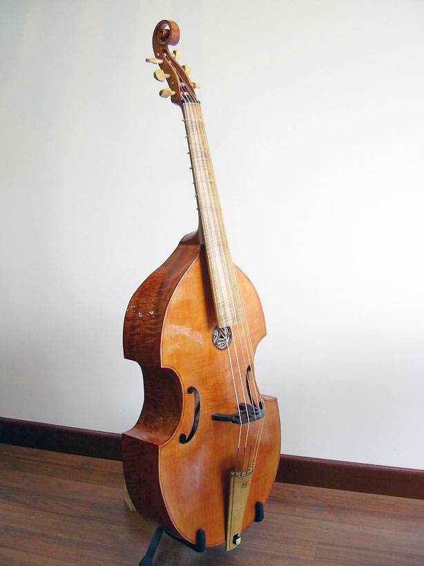 a cello sculpture sitting on a wooden floor