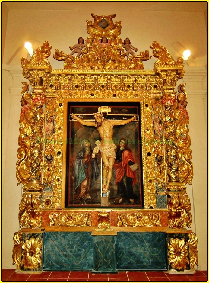 a gilded frame with paintings in the background