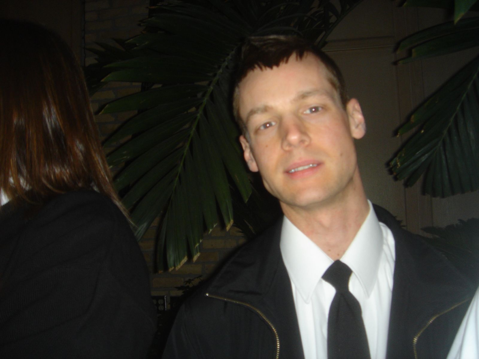 a man in a white shirt and black tie