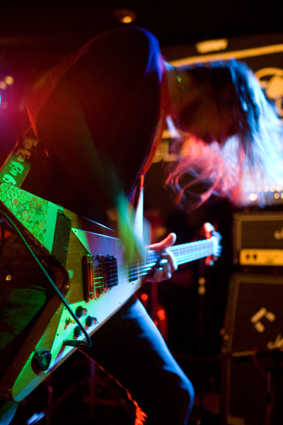 a person on a stage holding an electric guitar