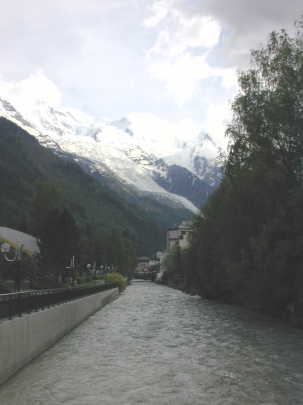 a river flowing through a mountain covered valley