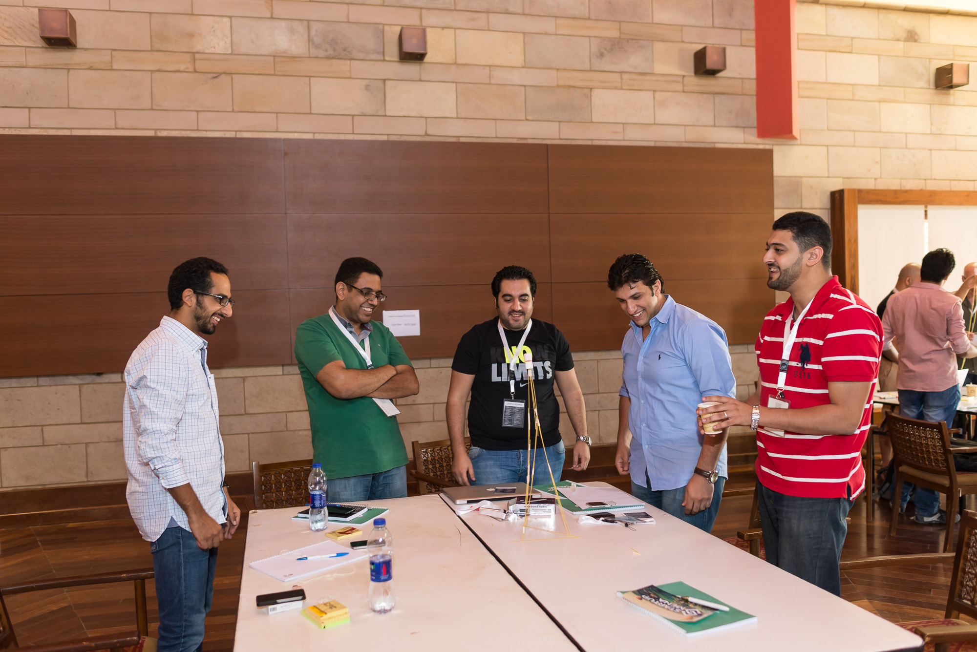 a group of men gathered in front of a table