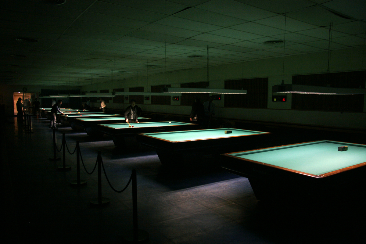 an empty pool is surrounded by green lights