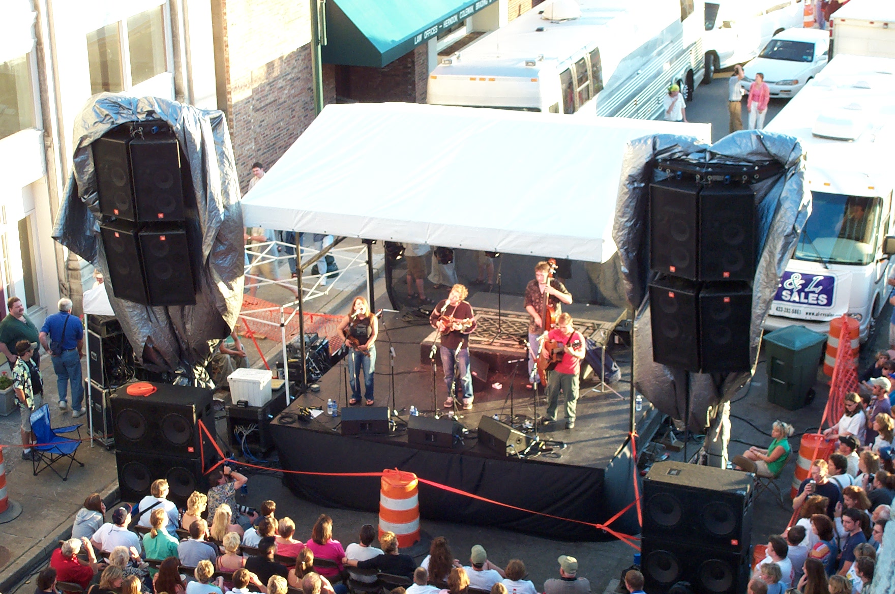 a band playing on stage surrounded by a crowd of people