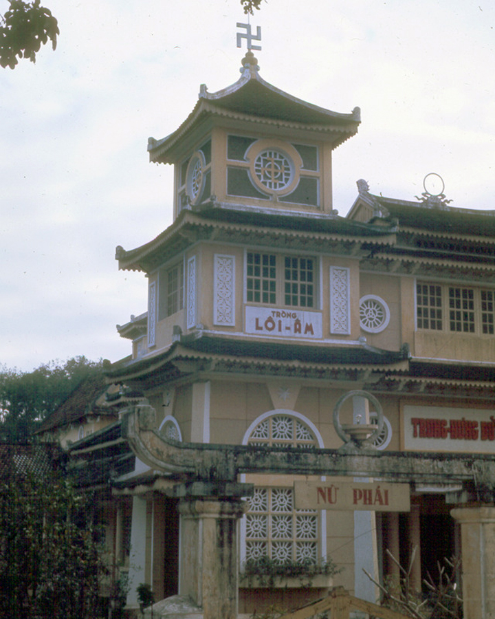 an old building in front of trees with a sky background