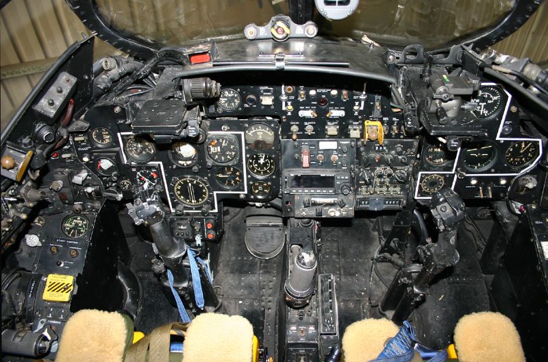 a pilot inside of a plane on a tarmac